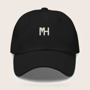 MH Essential Cap, black, front view, with a small cream MH monogram on the front