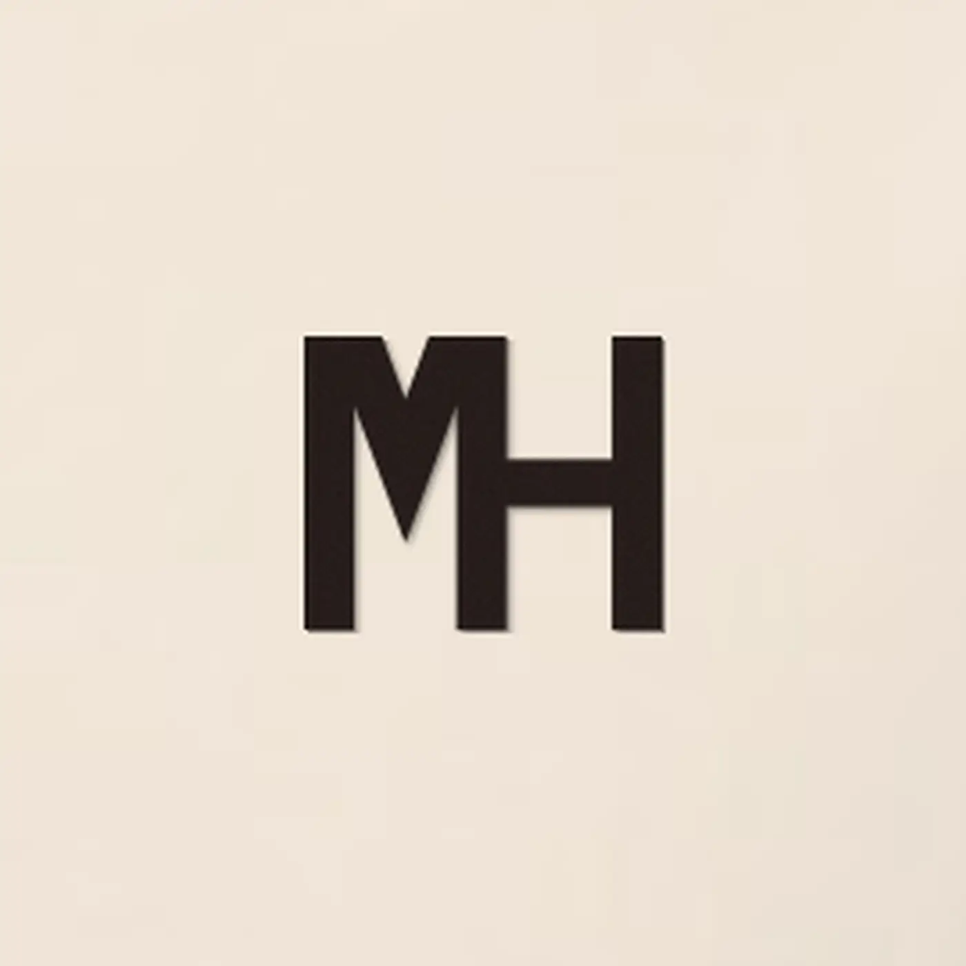 Close-up of a small espresso MH monogram embroidered on the MH Relaxed Hoodie