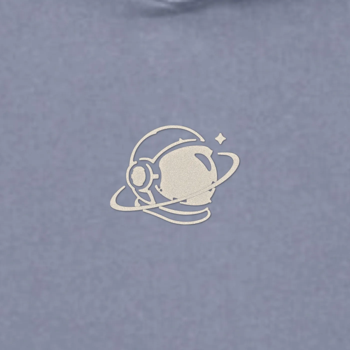 Close-up of the small cream MH astronaut at the centre chest embroidered on the MH Washed Astronaut Hoodie