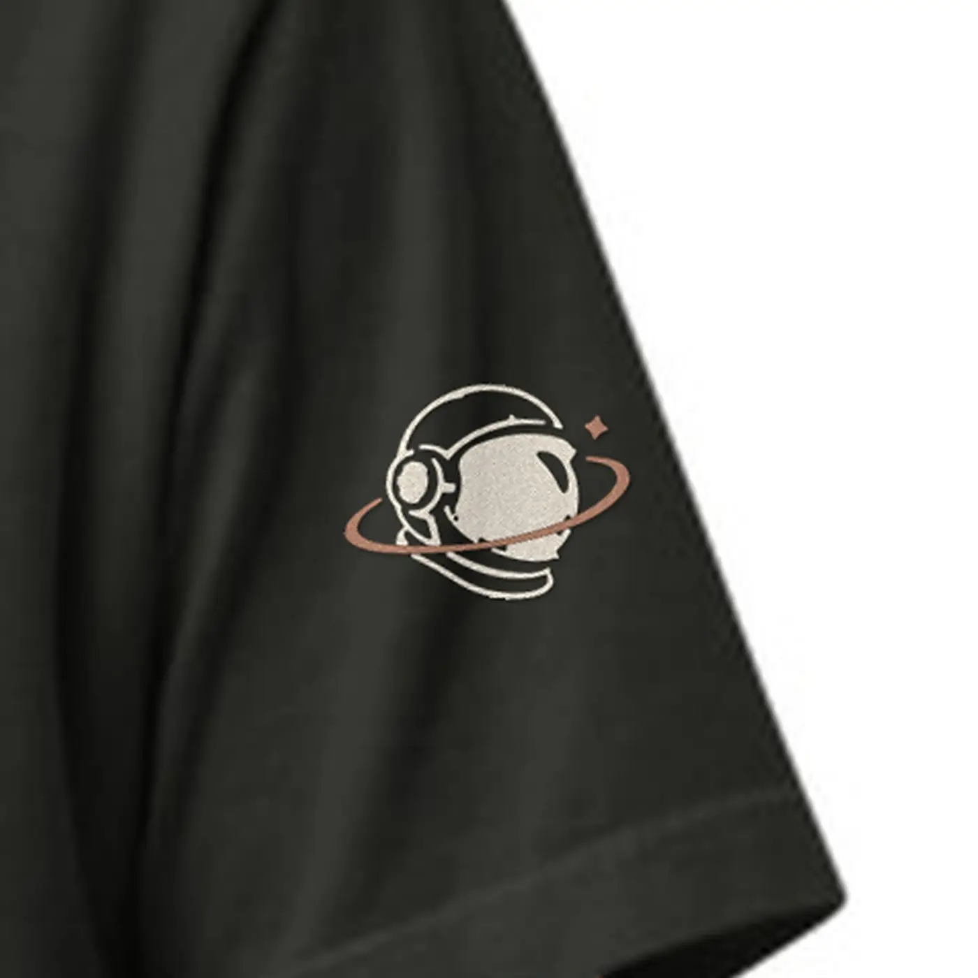 Close-up of the MH astronaut in cream and copper embroidered on the MH Explorer Tee